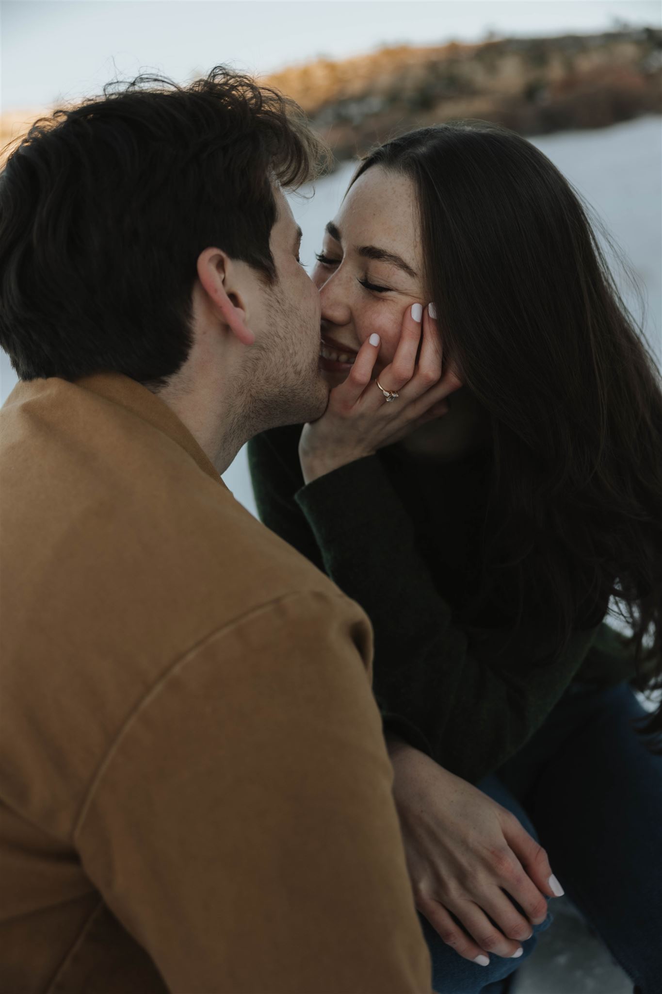 a man and woman about to kiss while smiling 