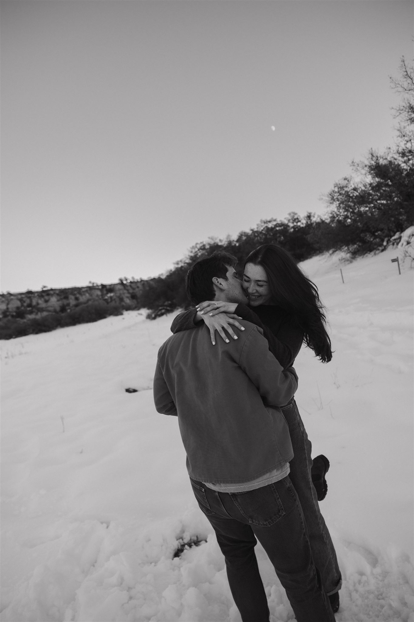 a man kissing a woman on her cheek 