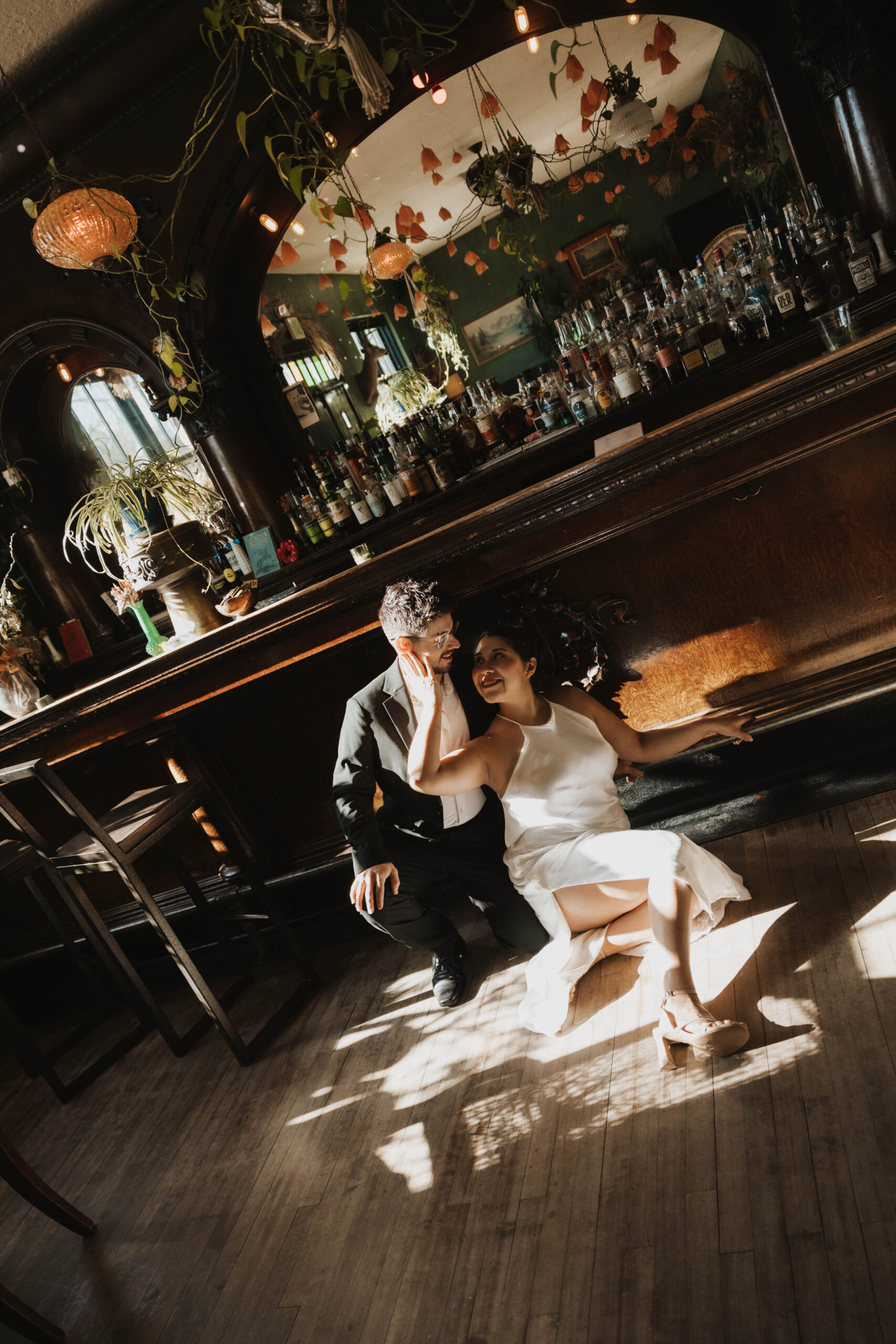 a couple sitting on the floor of the bar they first met 