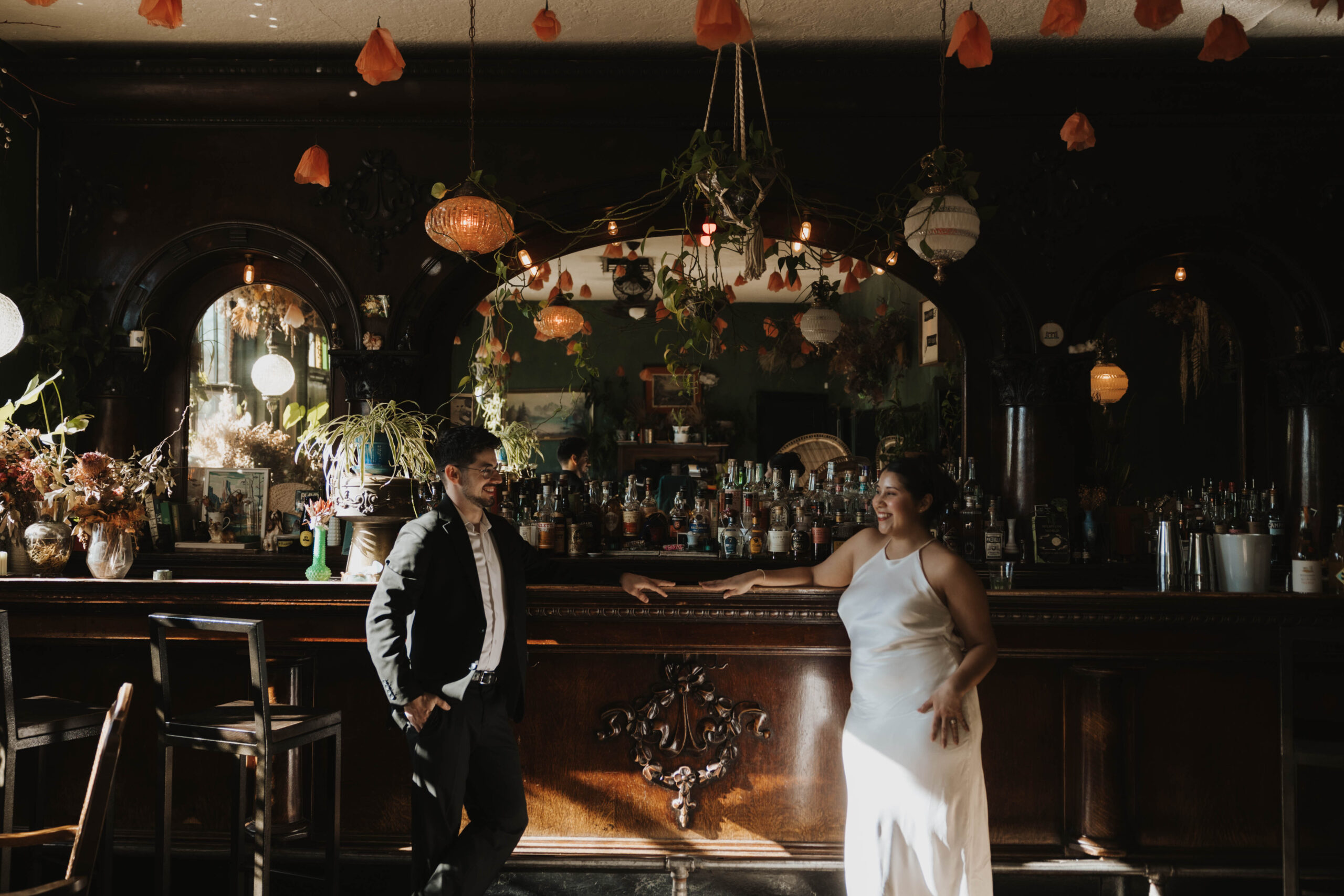 a couple at the bar they first met for their Denver Engagement Photo Location