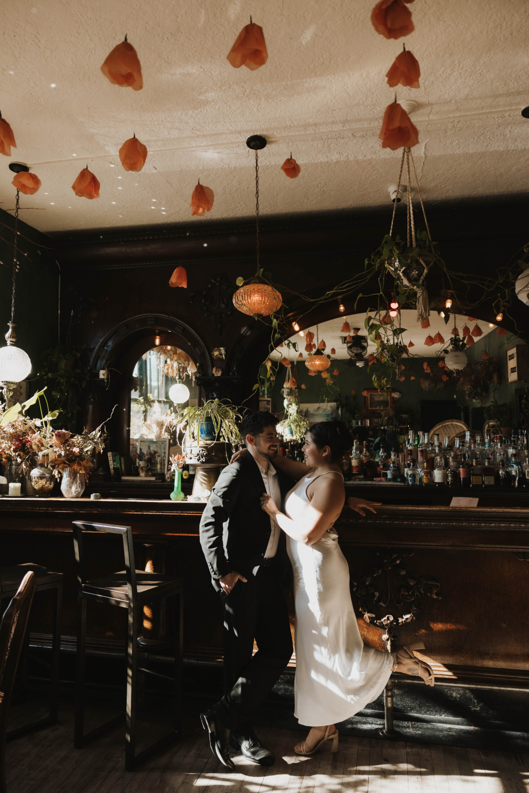 newly engaged couple standing at a bar together during their engagement session 