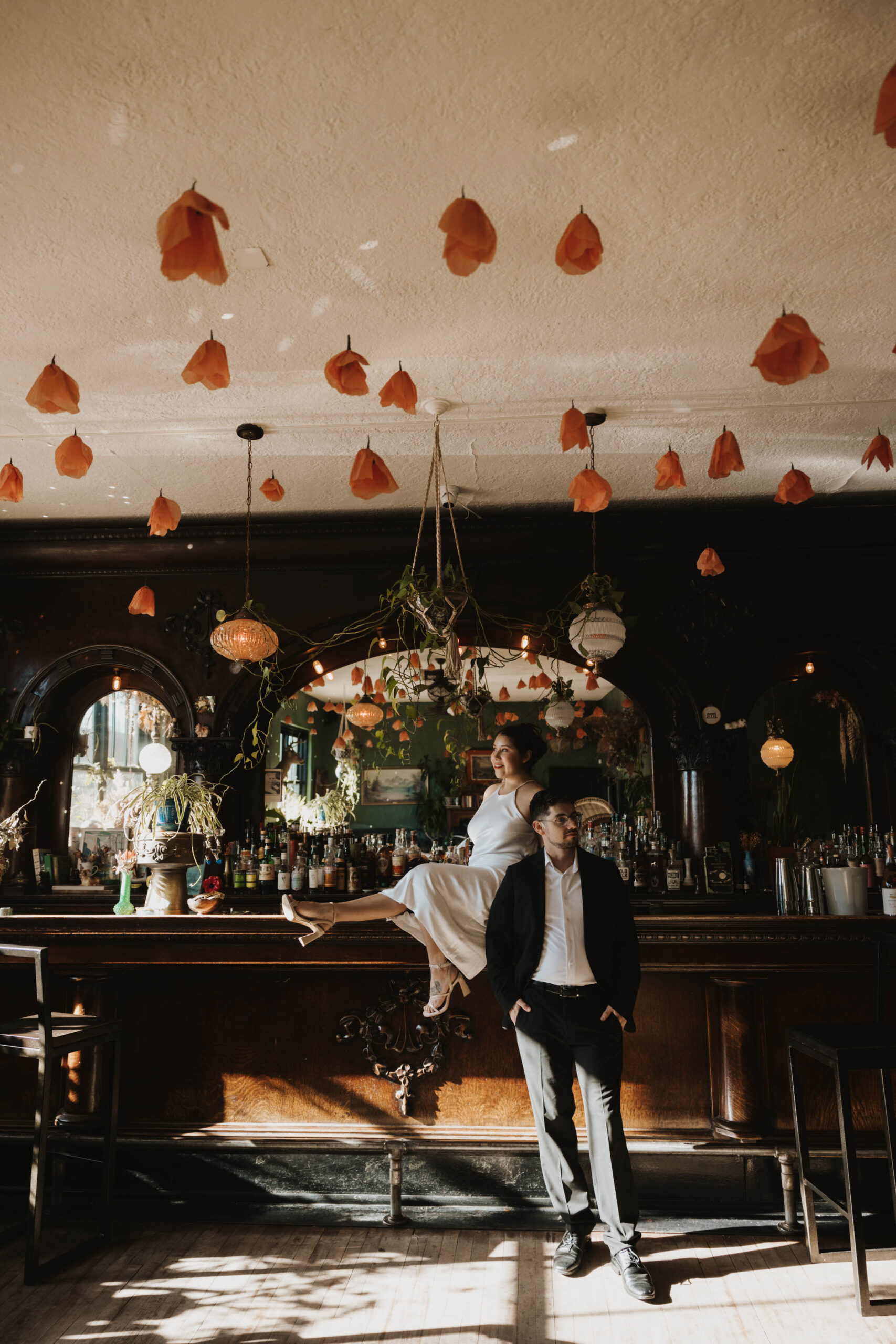 newly engaged couple taking photos in a bar 