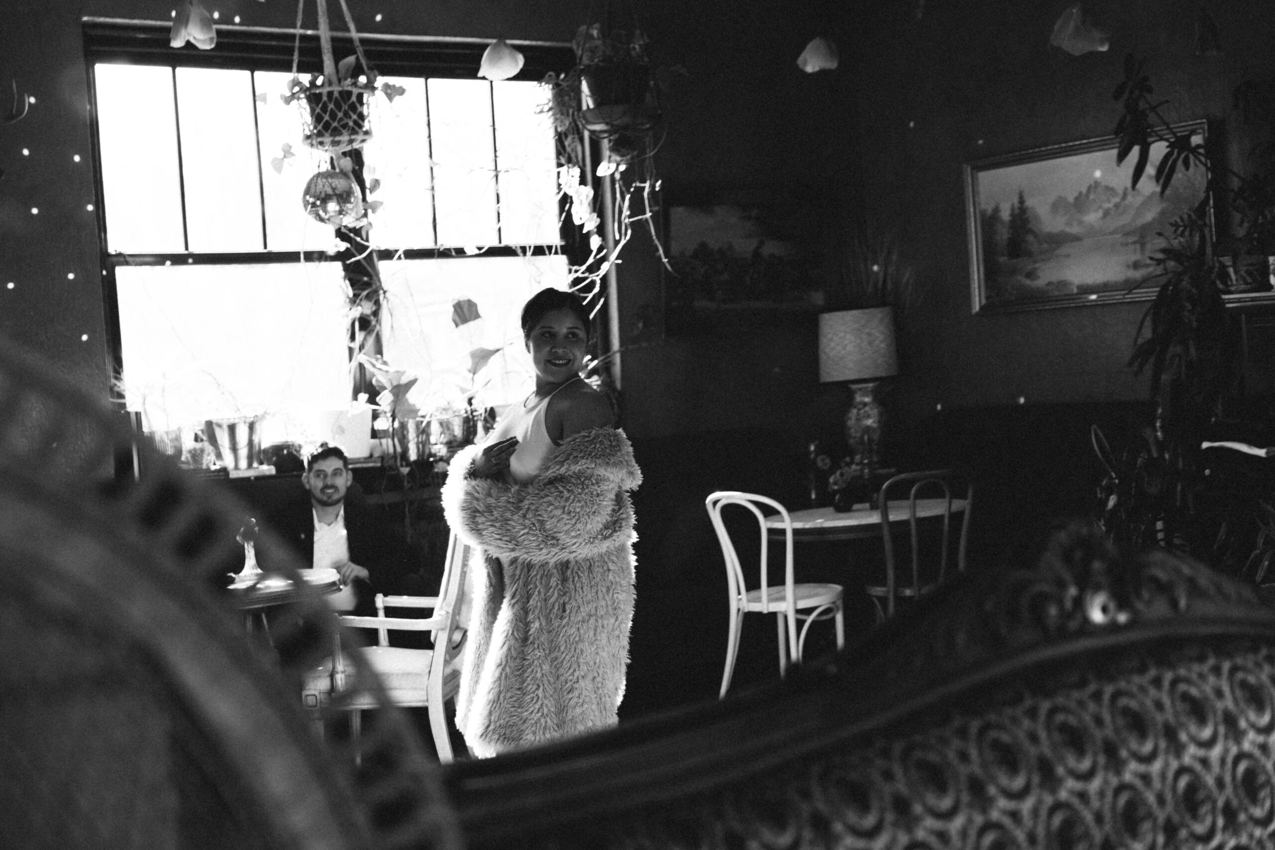 a man looking at a woman, captured through a mirror for their engagement photos 