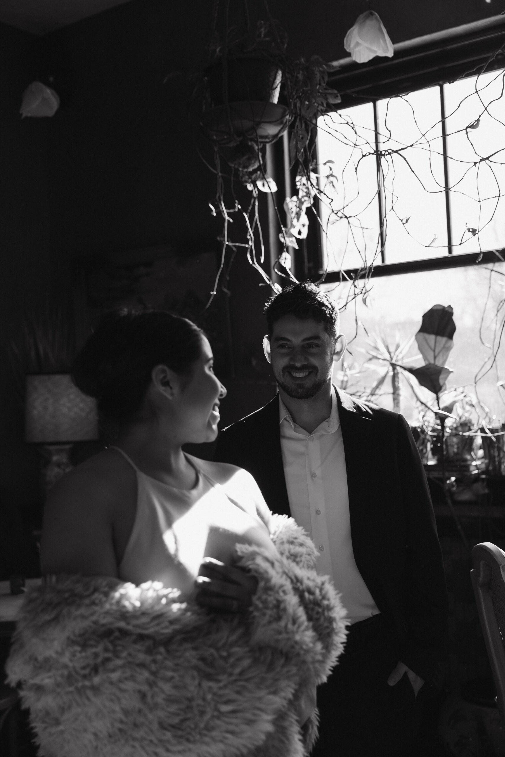 newly engaged couple smiling at each other at their Denver Engagement Photo Location