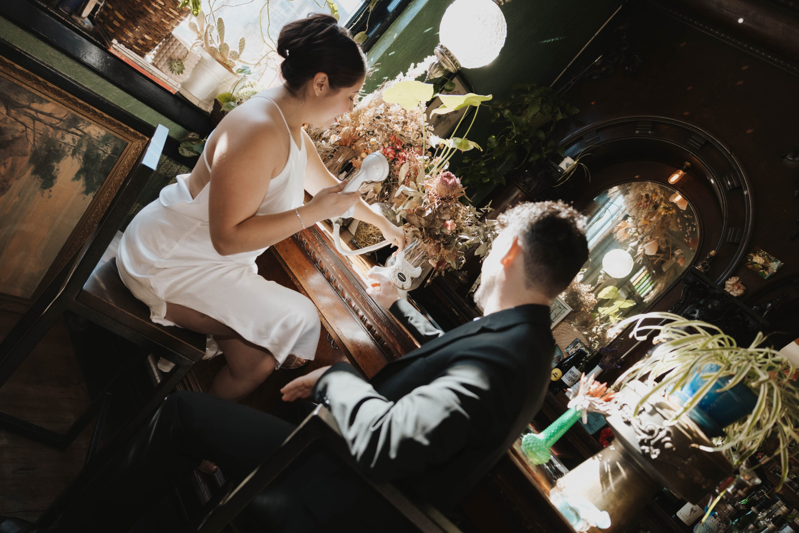 newly engaged couple sitting at a bar together for their Denver Engagement Photo Location