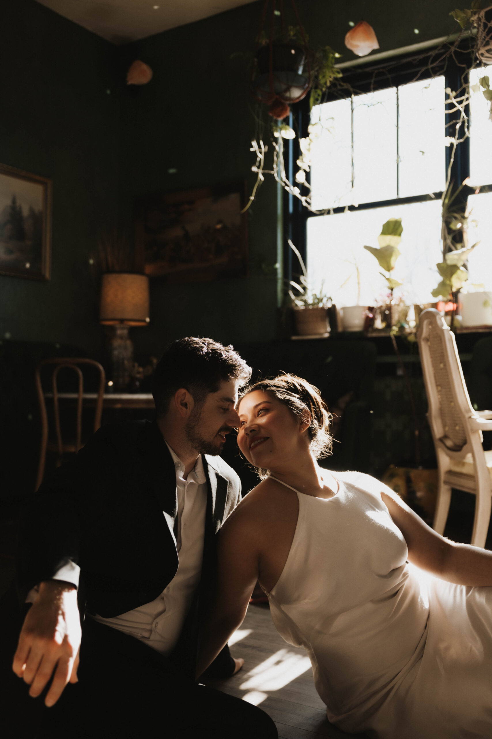 newly engaged couple about to kiss as they sit on the floor at their Denver Engagement Photo Location