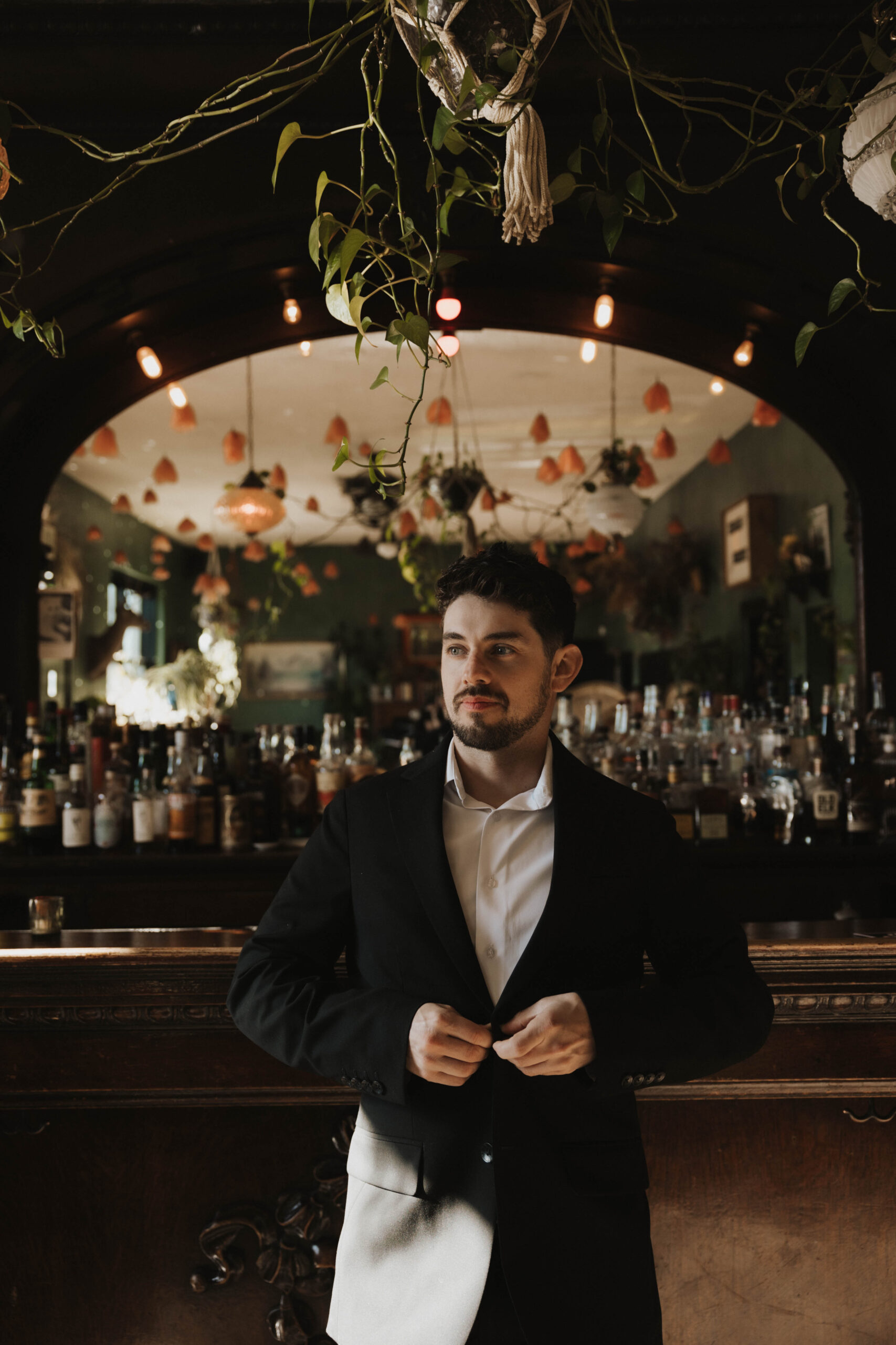 a man standing at the bar during his engagement photos 