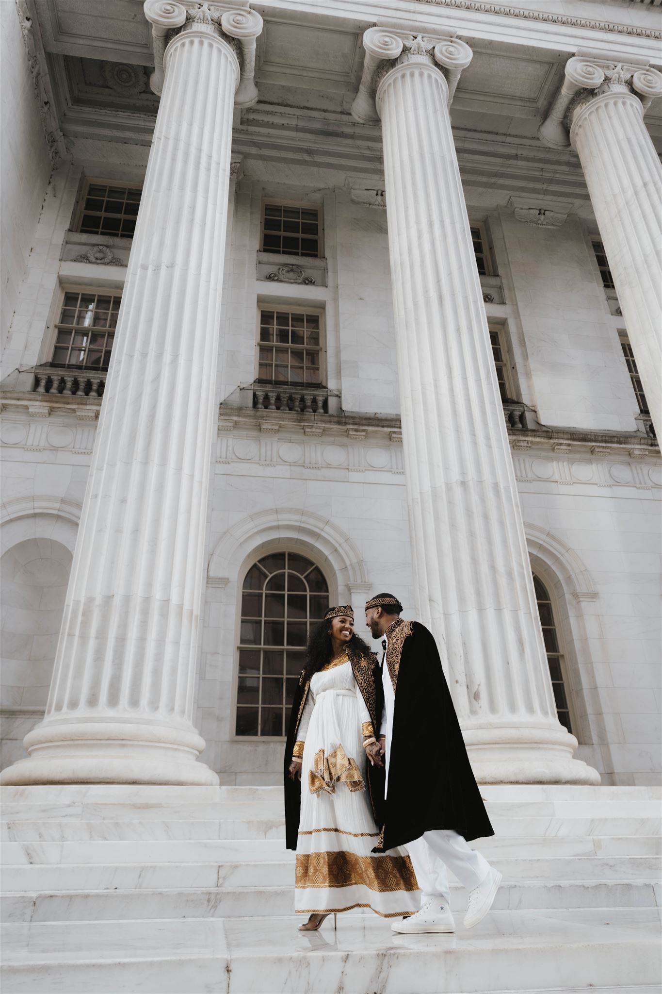 newly engaged couple walking outside the courthouse together 