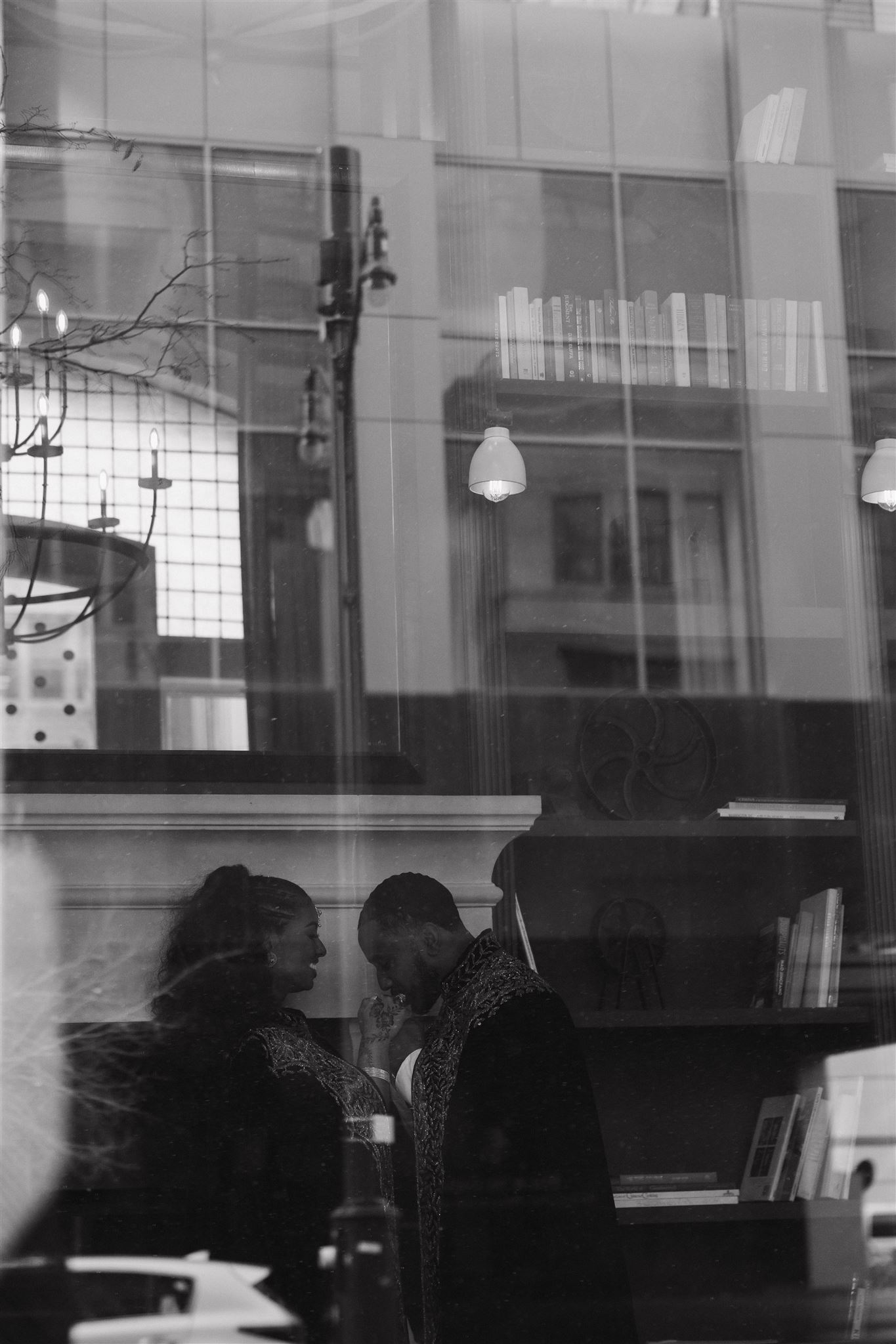 a couple through the window for their engagement photos