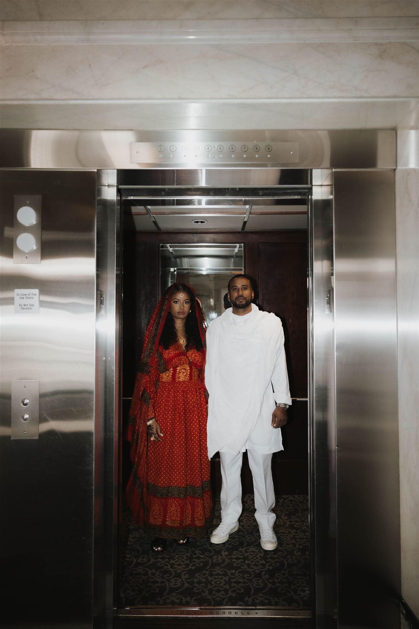 newly engaged couple in an elevator for their engagement photos